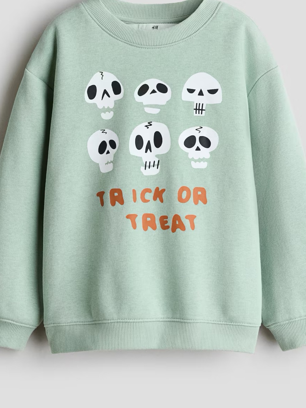 H&M Mint Green Crewneck Sweater with White Skull Motifs and Orange Text